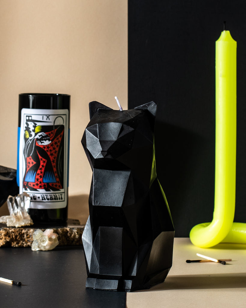 Dual candles being lit with a match. Dark collection featured in Ritual Shoppe, located in Philadelphia